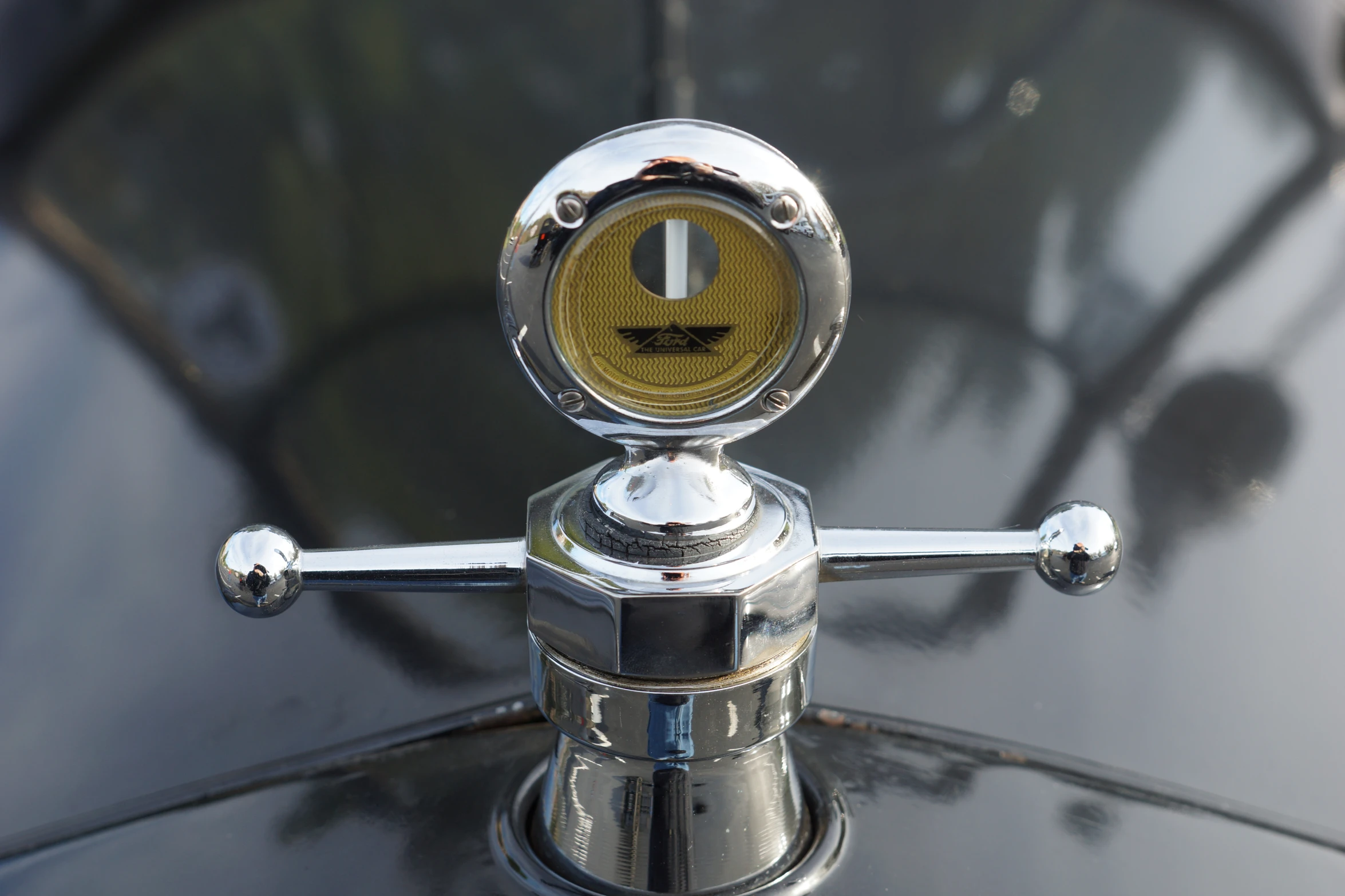 a shiny, chrome - clad automobile emblem on a shiny black background