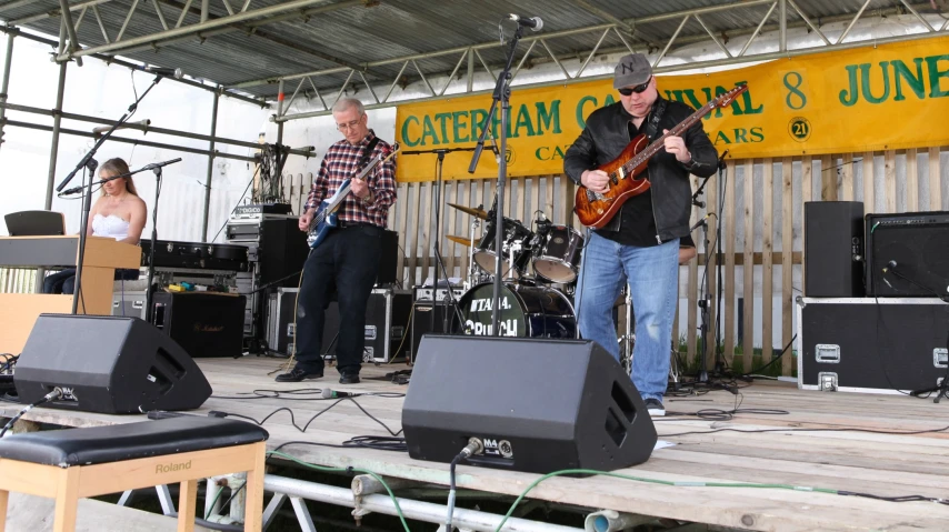 some people are on stage playing guitars and music