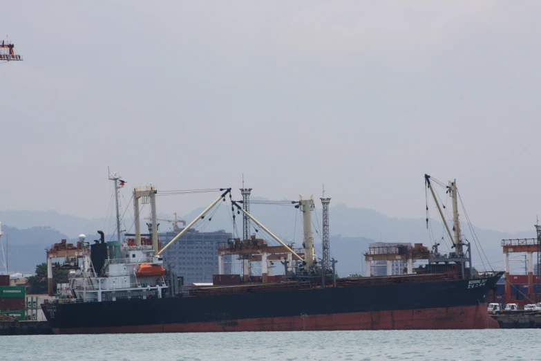 a large boat floating on top of water near mountains