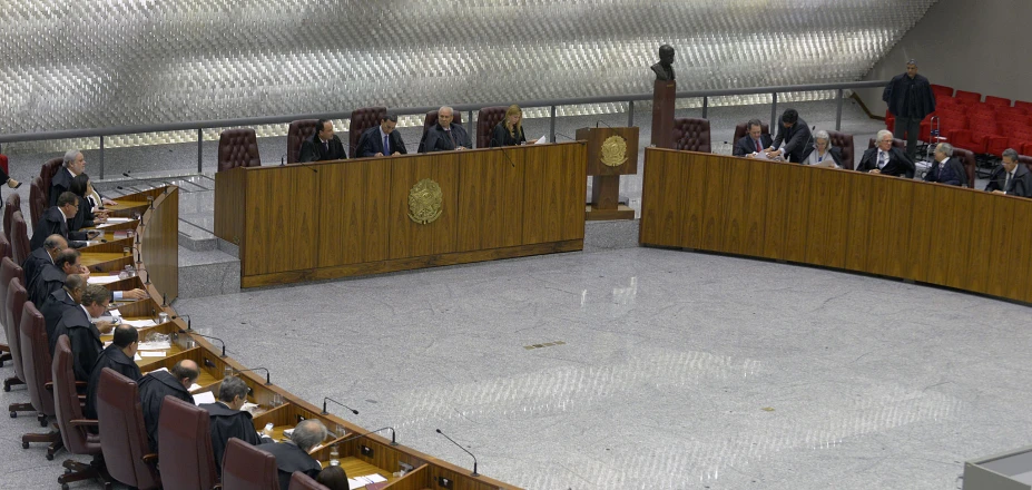 several people in suits are sitting and standing at the podiums