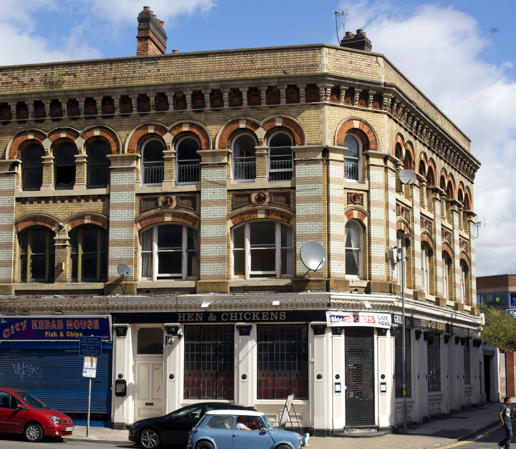 an old building with several windows and a sky background