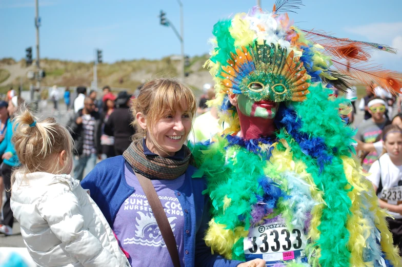 a woman and girl wearing feathers at a marathon