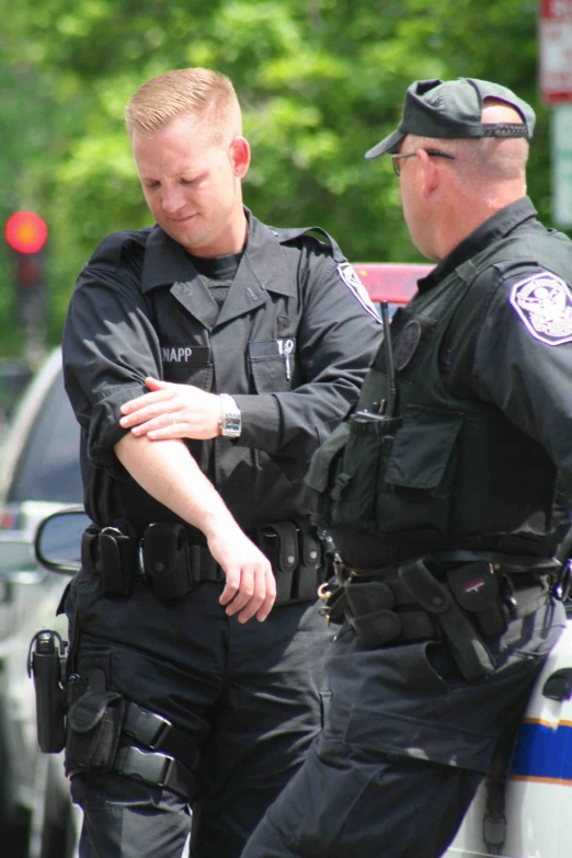 the two police officers are talking in the street