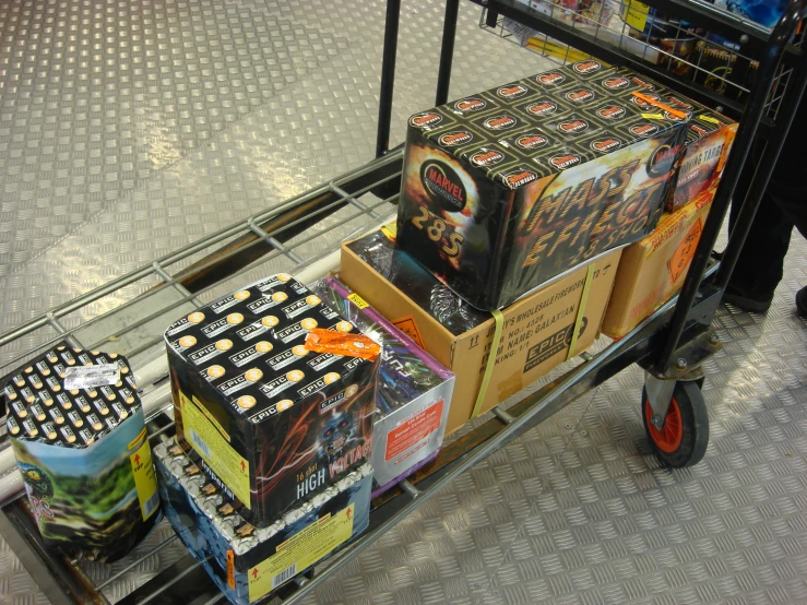 boxes of movies stacked on a shopping cart
