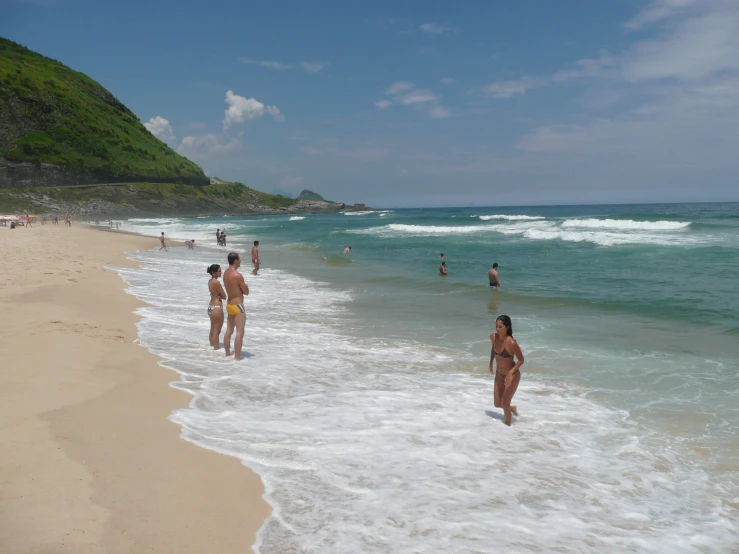 many people on the beach during the day