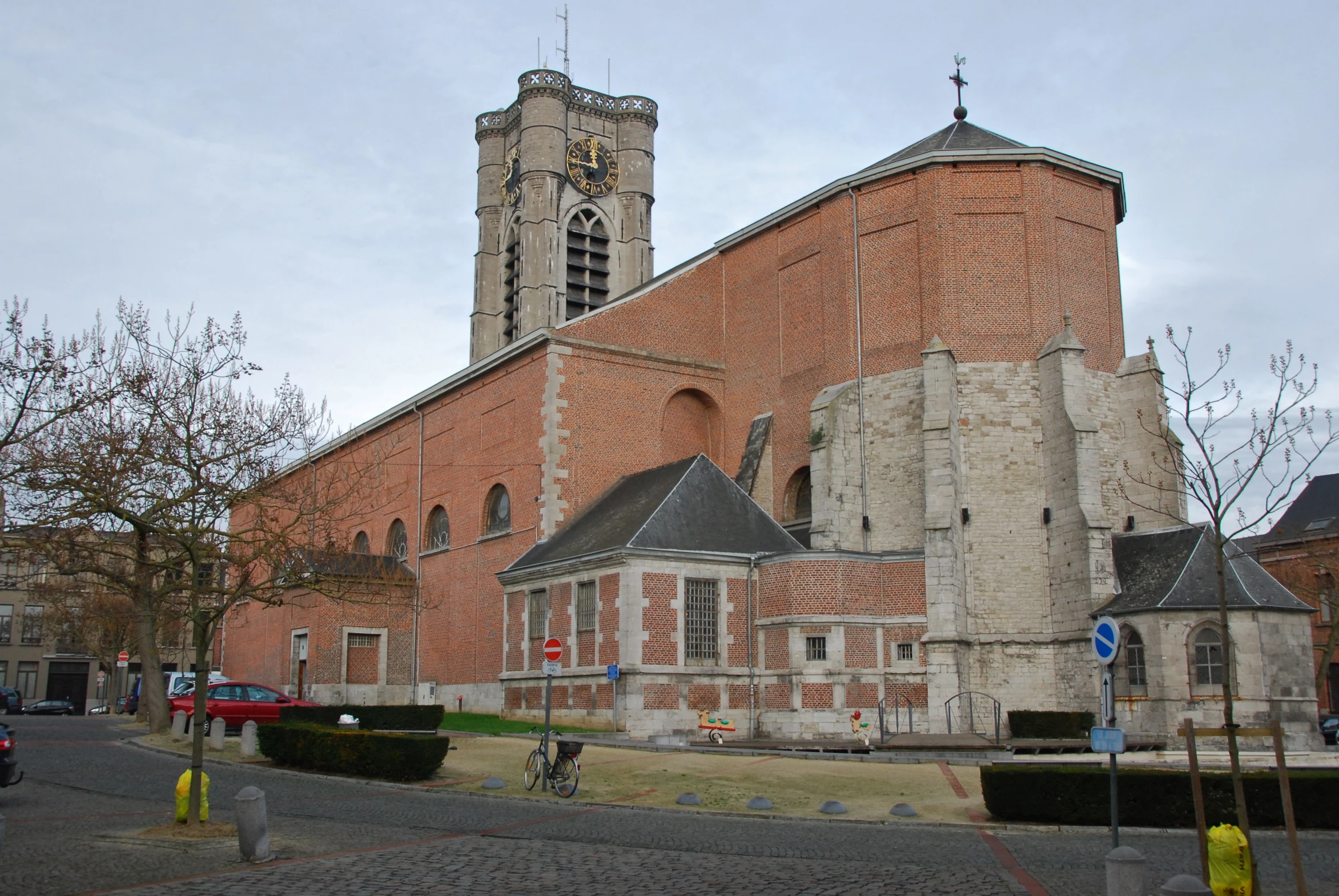 a stone building with a large clock tower behind it