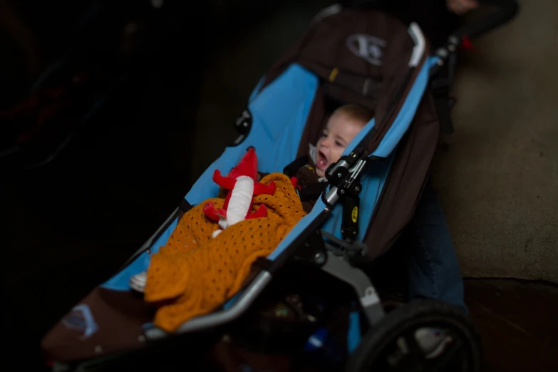 a baby is smiling in a baby stroller