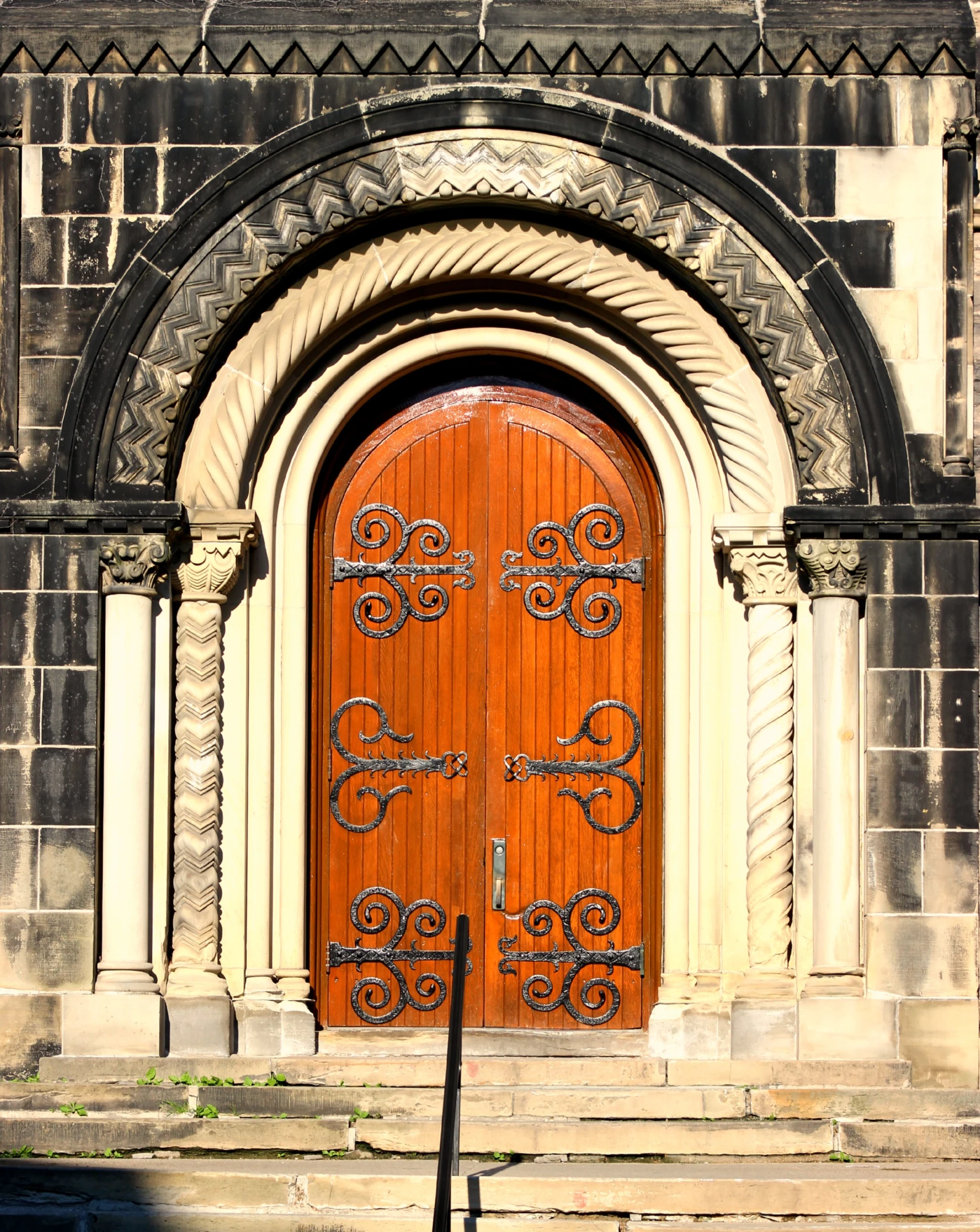 a tall building with a double wooden door and two steps