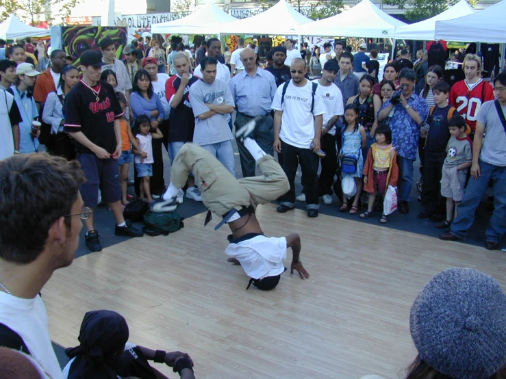 a man performing tricks on a skateboard in front of a crowd