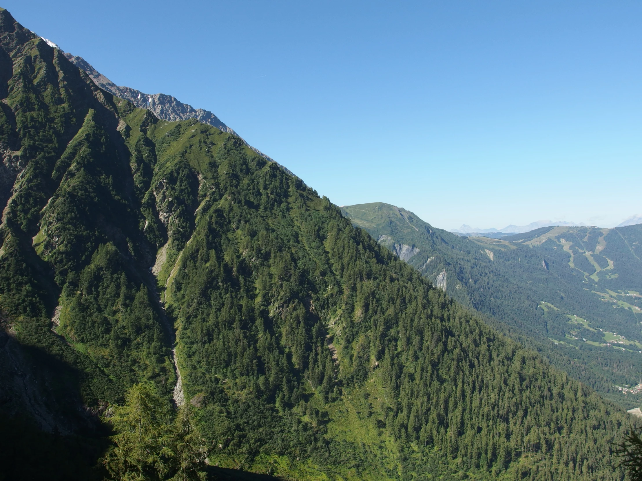 a beautiful mountain range with a river in the valley