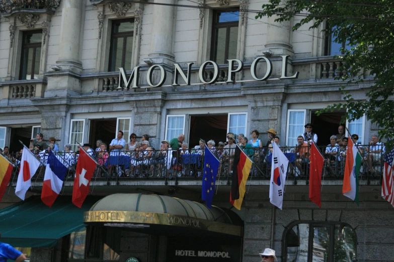 people are waving from the balcony of a building