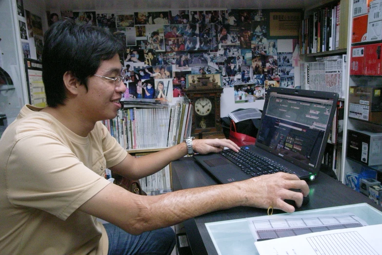 a man at a desk working on a laptop