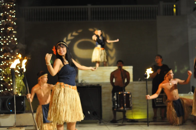 a woman with  dancing with her legs up while other people dance