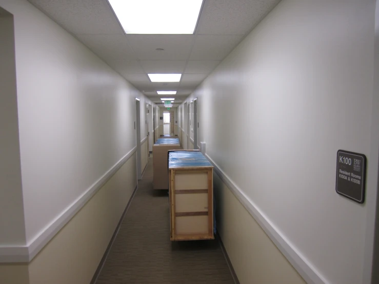 a long hallway in an hospital with no furniture