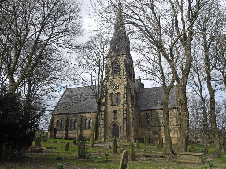 a old church with a cemetery in front of it