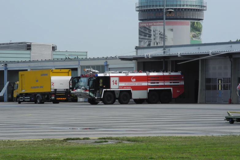 large trucks parked in front of an airport