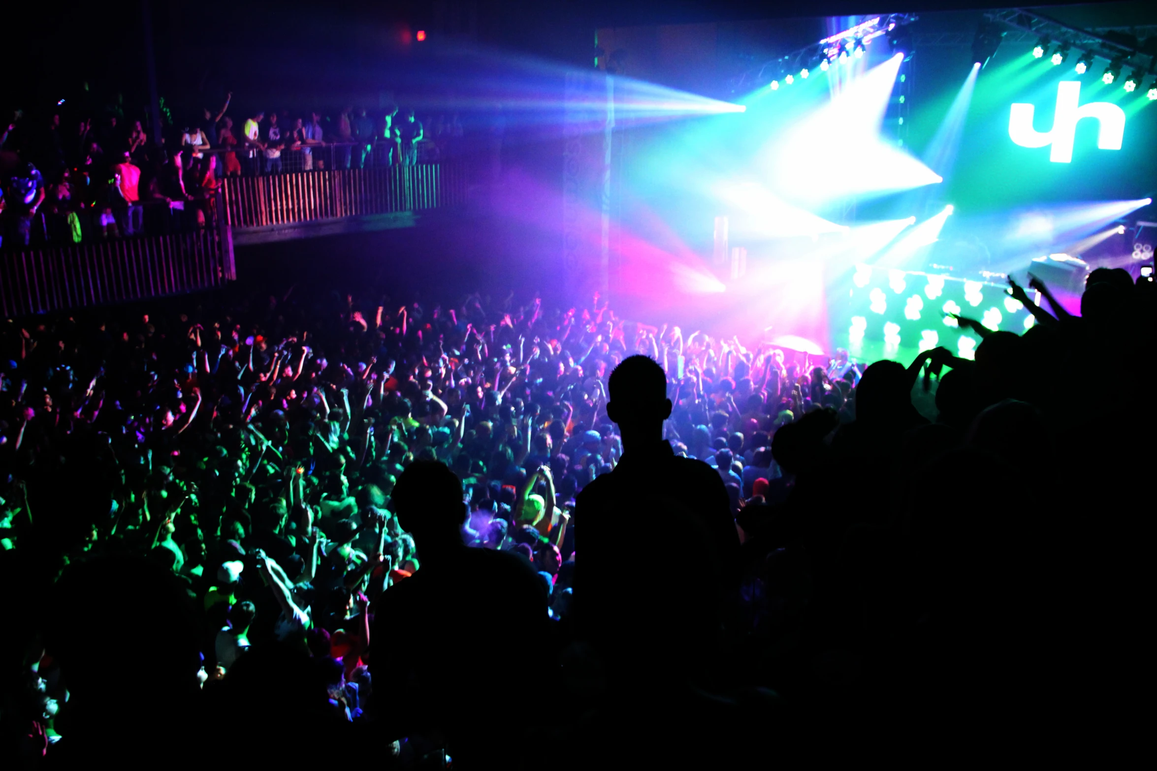 a silhouette of a crowd is shown at night at a concert