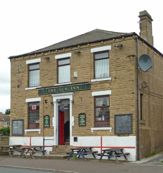 a brick building with a green door sitting on the corner