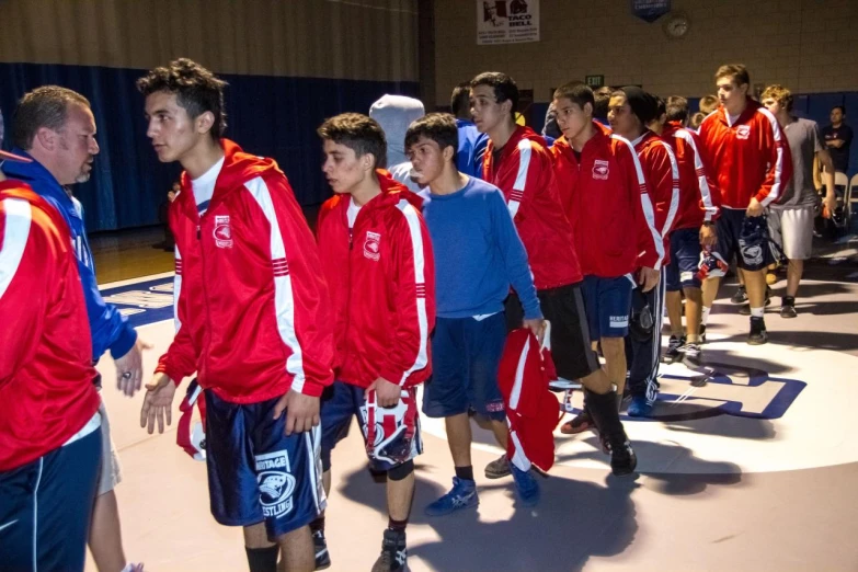 a bunch of boys in red and blue clothes