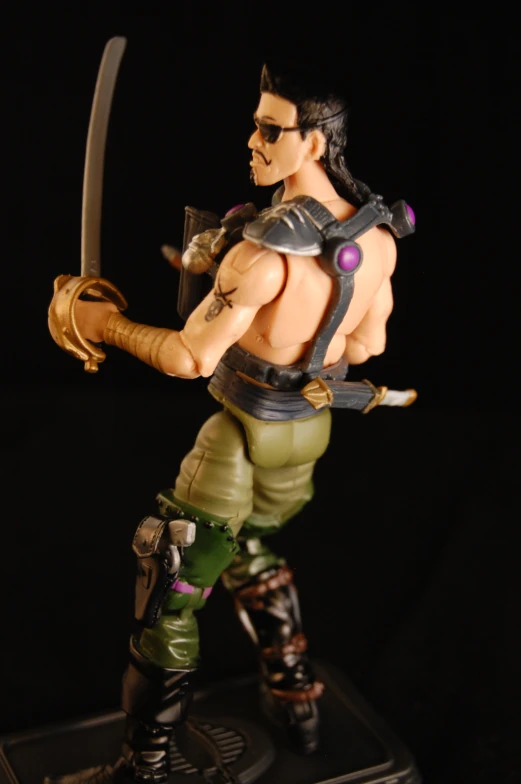 a toy man with large weapons is holding the object