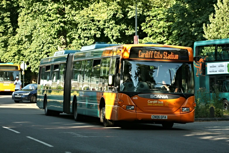 two buses driving side by side down a street