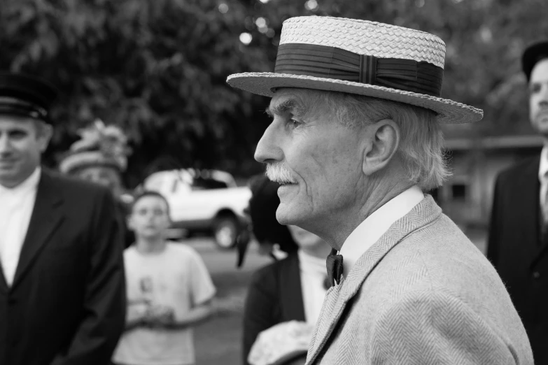 people standing around wearing suits and ties in the street