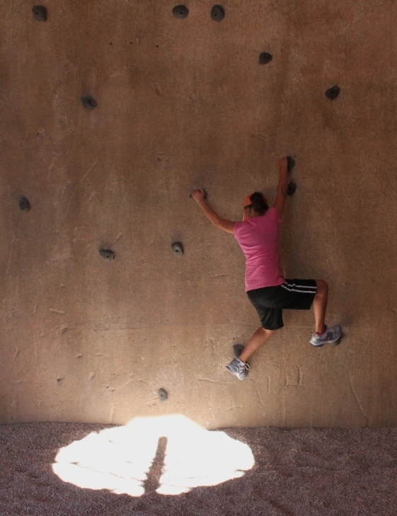 a man on a rock climbing wall in a tunnel