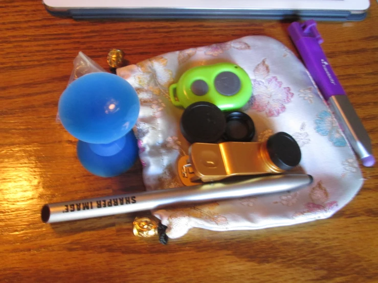 an assortment of accessories for small items such as a camera, marker and pen