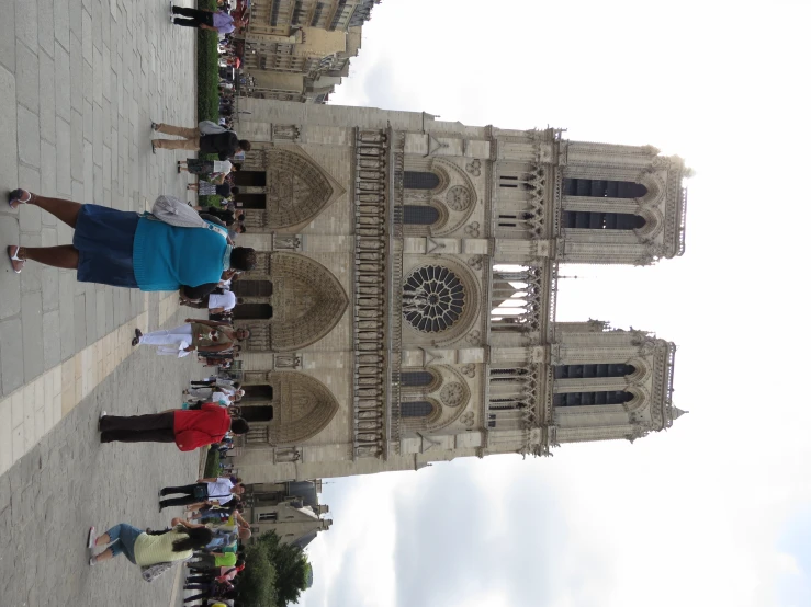 several people standing outside the gothic styled church