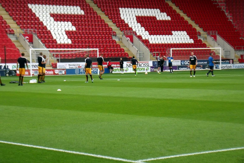 a group of men play soccer on a field