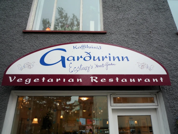 a vegetarian restaurant front and entrance on a building