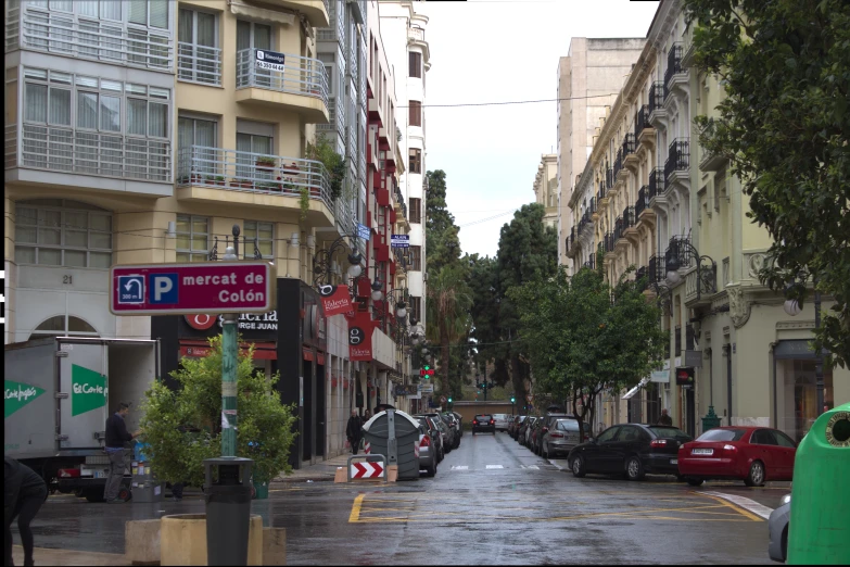 an empty city street with people and cars