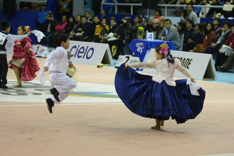 two dancers perform in front of an audience