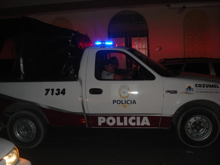 a police car with its lights on and a man in it