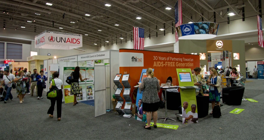 people walk around an exhibit at a convention