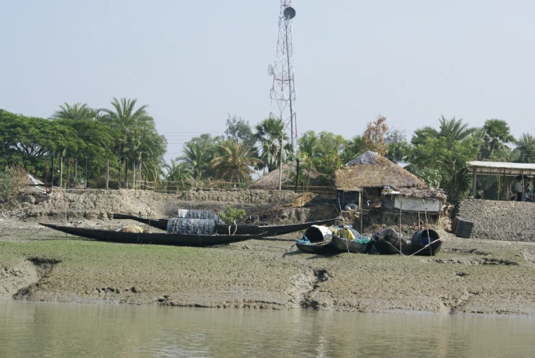 two boats tied to the side of a river