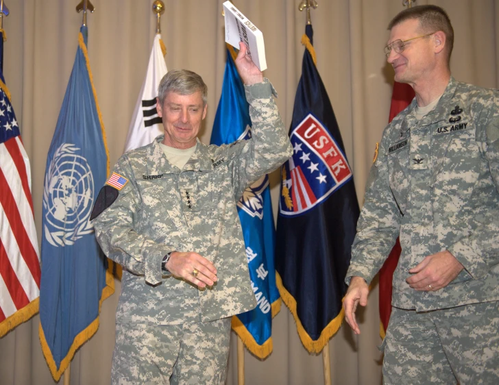 two people in uniforms giving the peace sign