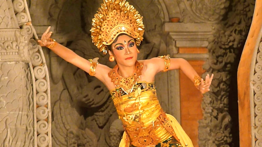 a woman with elaborate costume performing a cultural dance