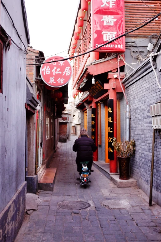 a person on a scooter is riding down the street