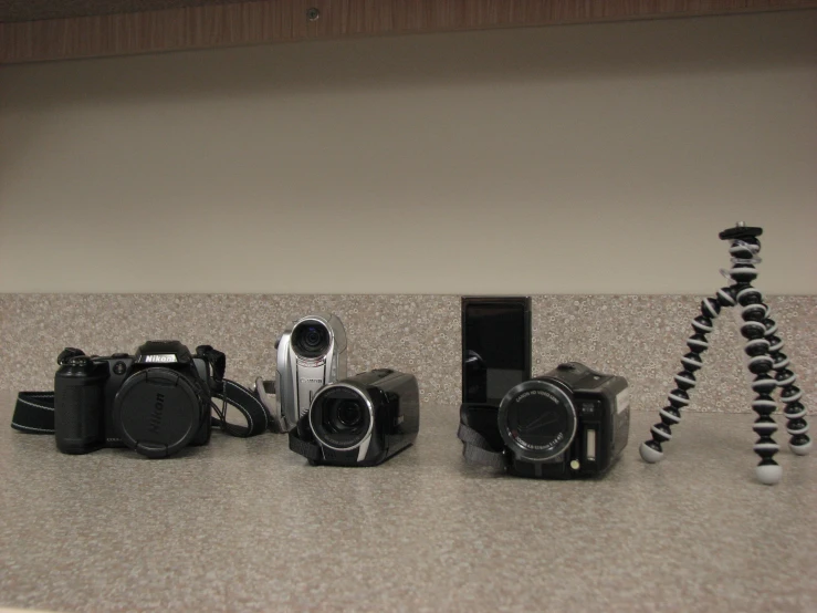 a group of cameras sitting on top of a counter