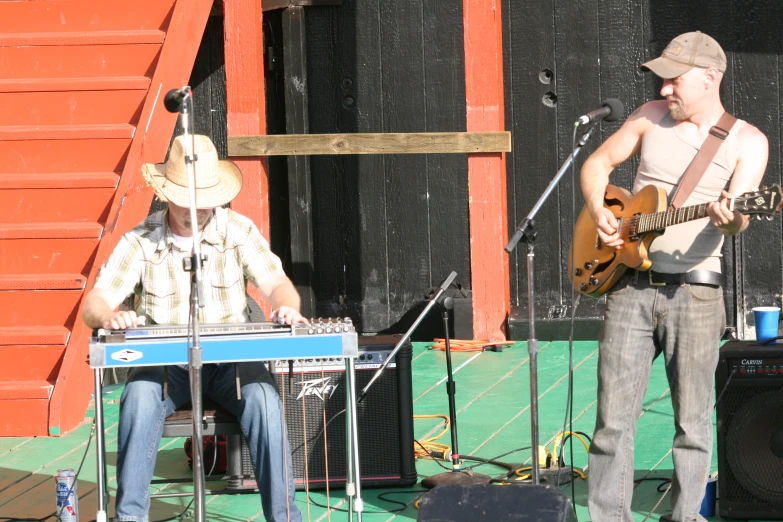 an old man playing music with a man on keyboard in front of him