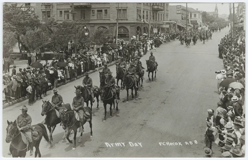 a large group of people on horses march down the street