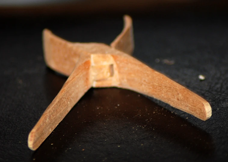 small piece of wood with the form of an airplane
