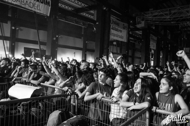 a group of people standing next to each other in a cage