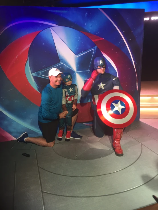 the avengers two are posed in costumes and holding a shield