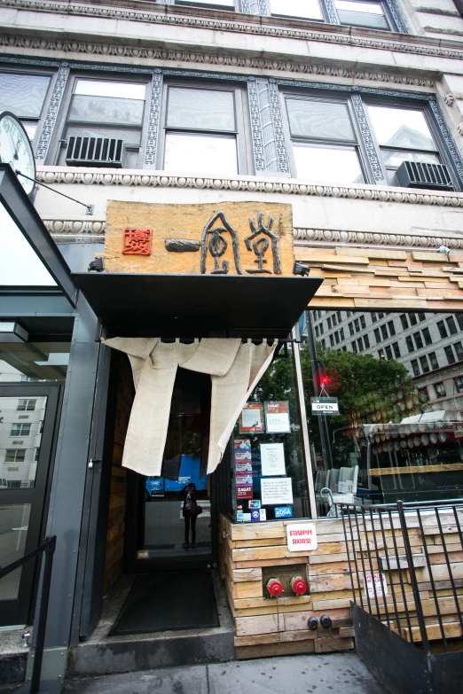 a storefront with an awning next to the entrance