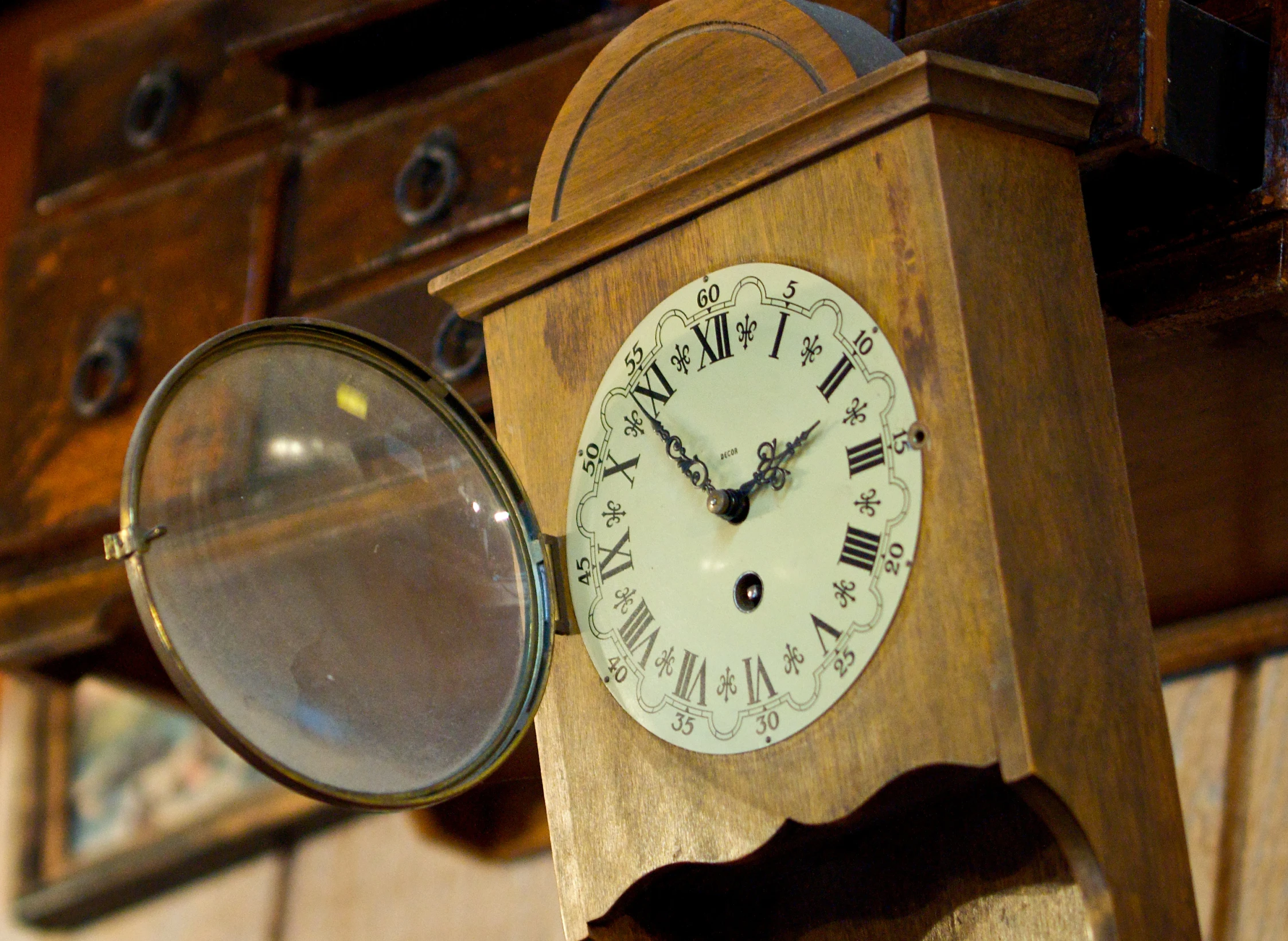 an old clock with a magnifying glass on a wooden stand
