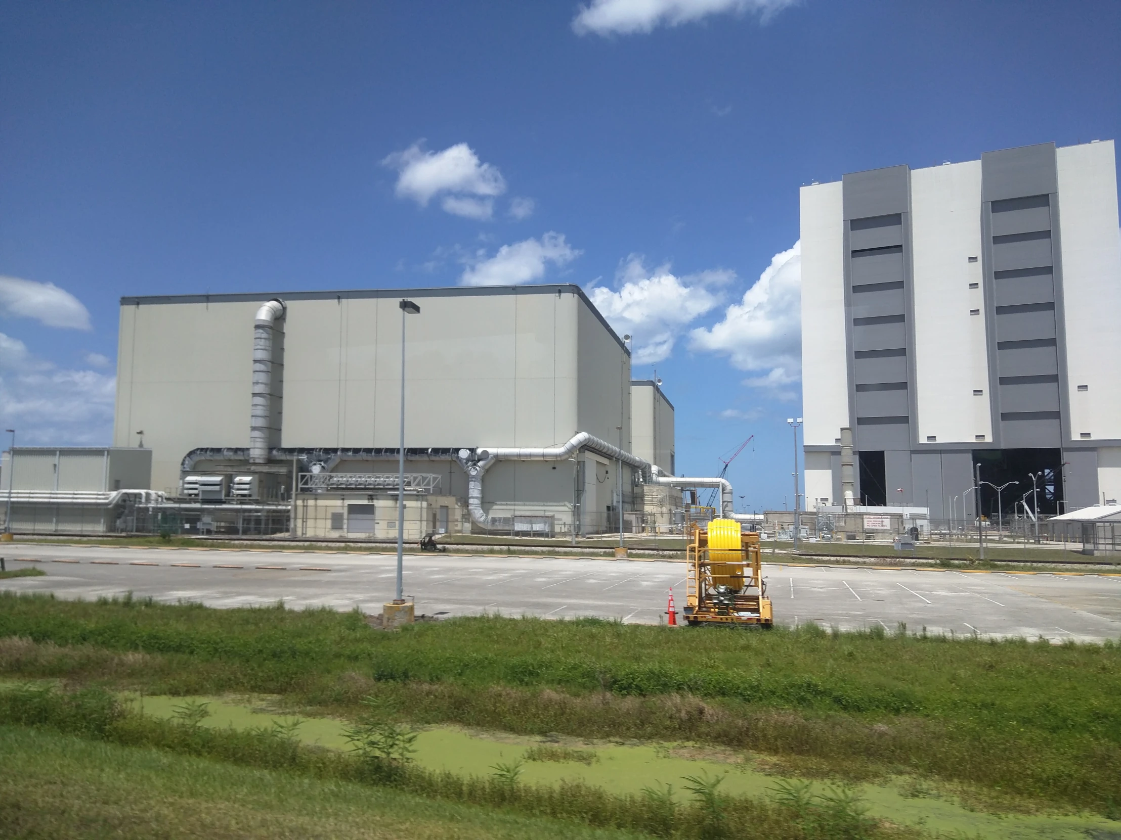 a tractor parked in front of an industrial plant