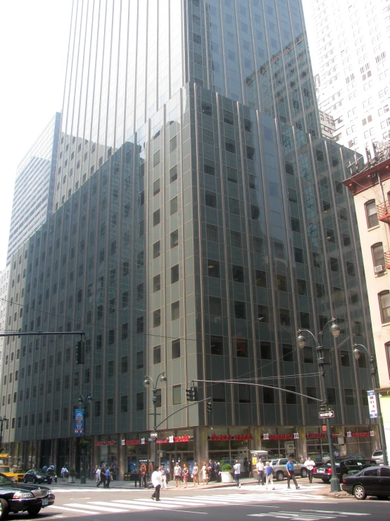 a view of an intersection with a tall building