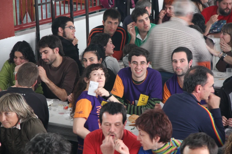 people sitting in the stands at an outdoor dinner